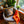 Load image into Gallery viewer, Chair with a tiger pillow and orange blanket in a room with plants and framed artwork.
